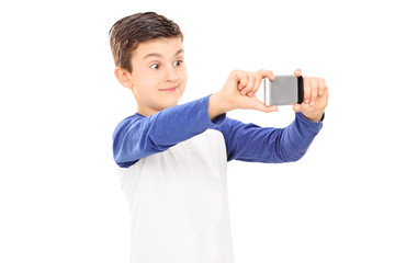 Little kid taking a selfie with cell phone