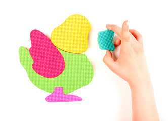 Hand and multicolored foam puzzle