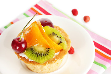 sweet cake with fruits on plate isolated on white