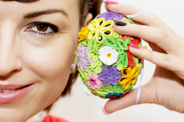 Young smiling woman with colorful easter egg