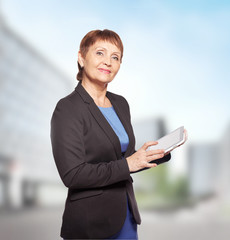 attractive woman 50 years old with a tablet in hands