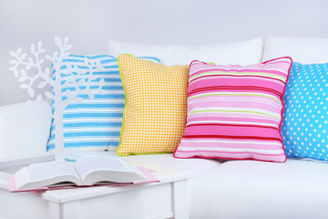 White sofa with colorful pillows in room