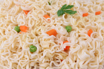 Tasty instant noodles with vegetables close-up