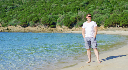 Attractive young man on tropical beach.