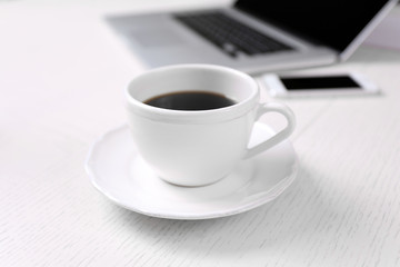 Fototapeta na wymiar Cup of coffee at workplace