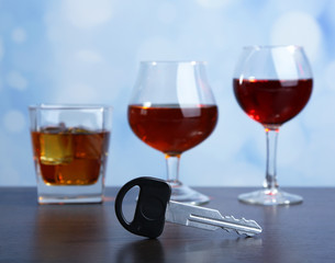 Composition with car key and glasses of drinks,
