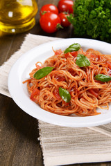 Pasta with tomato sauce on plate on table close-up