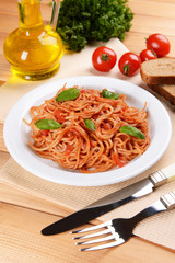 Pasta with tomato sauce on plate on table close-up