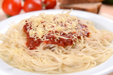 Pasta with tomato sauce on plate on table close-up