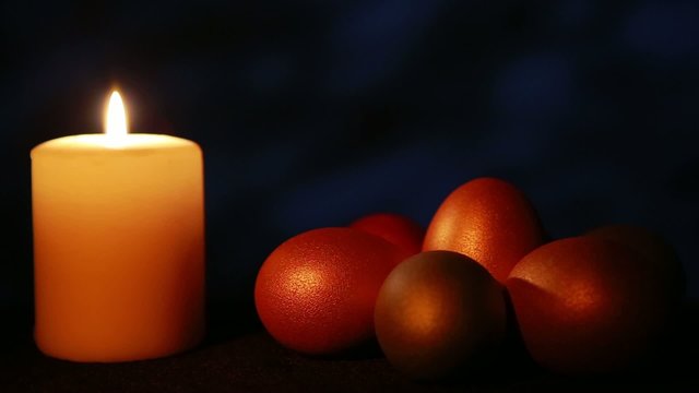 Easter candle with ornaments in the dark