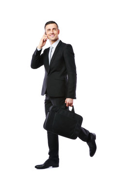 Businessman Walking And Talking On The Phone 