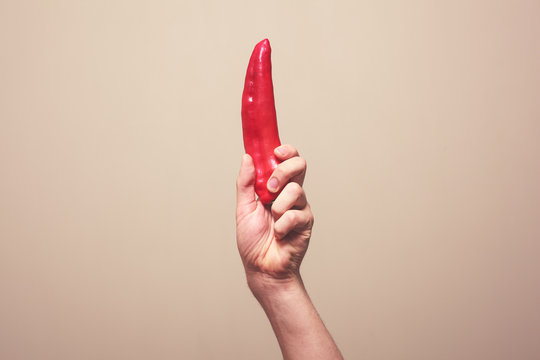 Hand holding red pepper