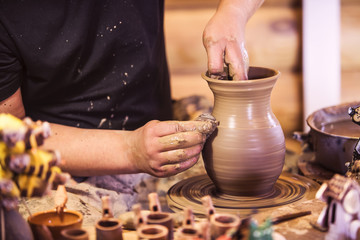 Fototapeta na wymiar Close-up of hands making pottery on a wheel