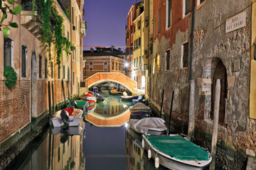 Venice canal at night with beautiful reflections
