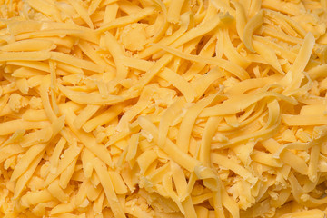 Grated cheddar cheese on a plate