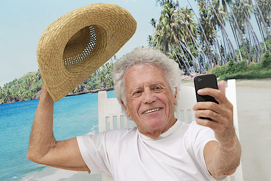 Senior man on vacation taking picture of himself