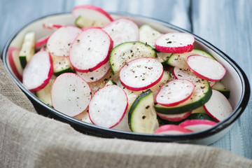 Close-up of radish and cucumber salad, horizontal shot