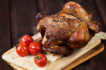 Whole baked chicken with cherry tomatoes on pita bread