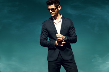 Outdoors fashion portrait. Man with glasses.