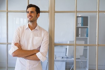 Casual businessman smiling with arms crossed