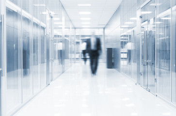 businessman goes along a corridor at modern office