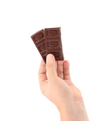 Hand holds dark chocolate bars.