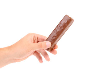 Hand holds tasty chocolate.