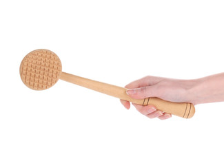 Hand holds wooden meat tenderizer.