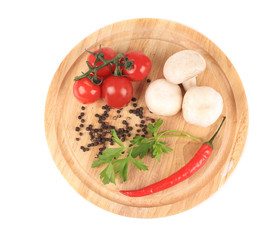 Fresh vegetables on wooden platter.