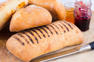bread rolls with jars of jam