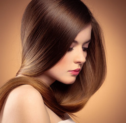 Tender woman with perfect shiny long hair posing in studio