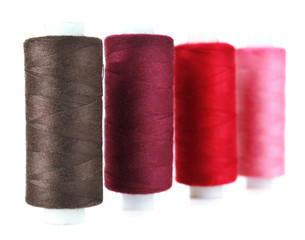 Colored spools of threads isolated on white