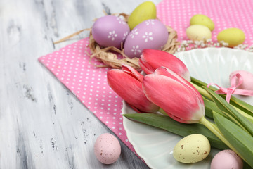 Obraz na płótnie Canvas Easter table setting with tulips and eggs