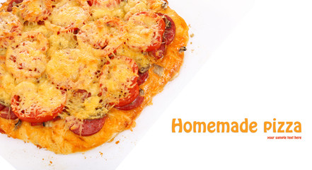 Homemade pizza on baking paper isolated on white