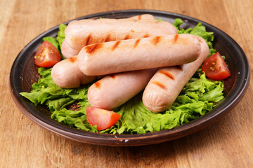 Grilled sausage on plate on table close-up