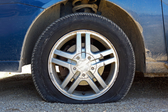 Flat Car Tire On Gravel Road