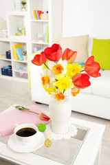 Beautiful spring flowers in vase on home interior background