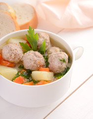 Meatball soup in white bowl
