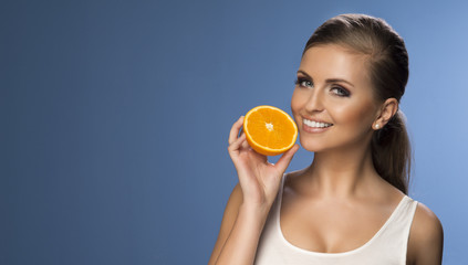 Portrait of a young beautiful woman with orange