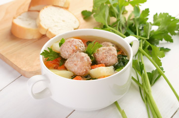 Meatball soup in white bowl
