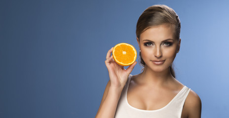 Portrait of a young beautiful woman with orange