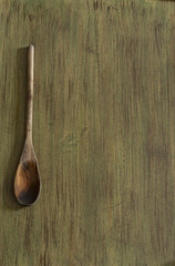Wooden kitchenware on green background