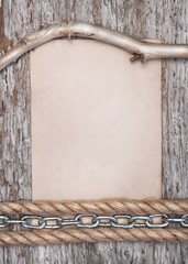Paper, dry branch and metal chain on the old wood