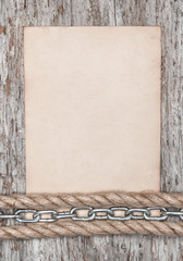 Old paper and metal chain on the old wood