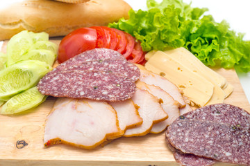Sandwich ingredients on a wooden board against white background