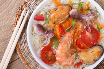 Asian seafood soup close-up on the table. top view