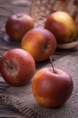 Fototapeta na wymiar red apples on wooden table, selective focus