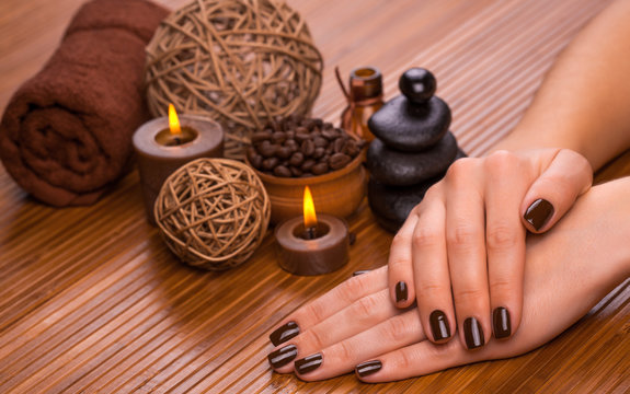 brown manicure on a bamboo background