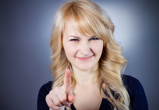 Woman pointing finger at you and smiling