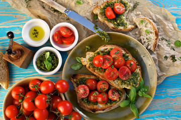 Bruschetta with fresh cherry tomatoes and aromatic herb pesto